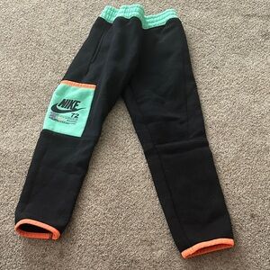 Nike Illuminate graphic pants size 5Kids Black and Mint Joggers with Orange Trim